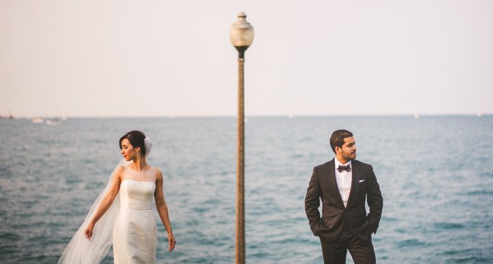 couple standing side by side with ocean backdrop