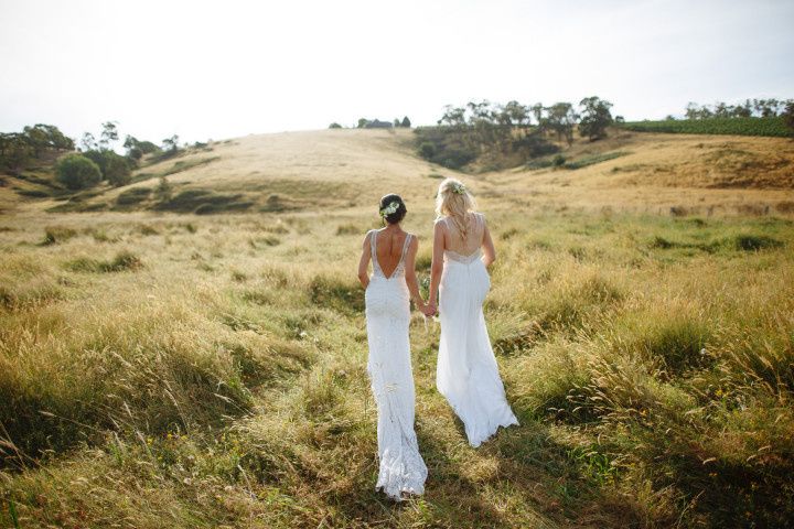 two brides walking hand in hand
