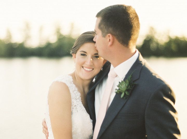 bride and groom with water backdrop