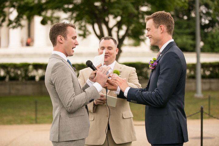 same-sex couple exchanging handwritten wedding vows and rings