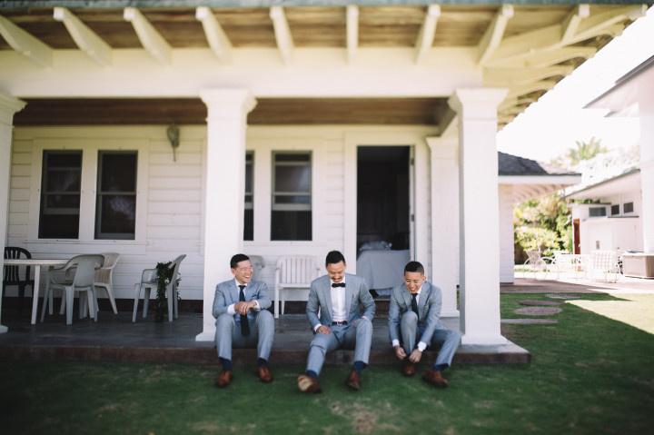 groomsmen putting shoes on