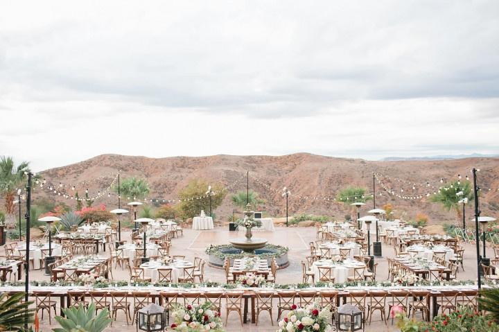 aerial view of outdoor wedding venue hummingbird's nest ranch long banquet tables set up with mountain view in the background