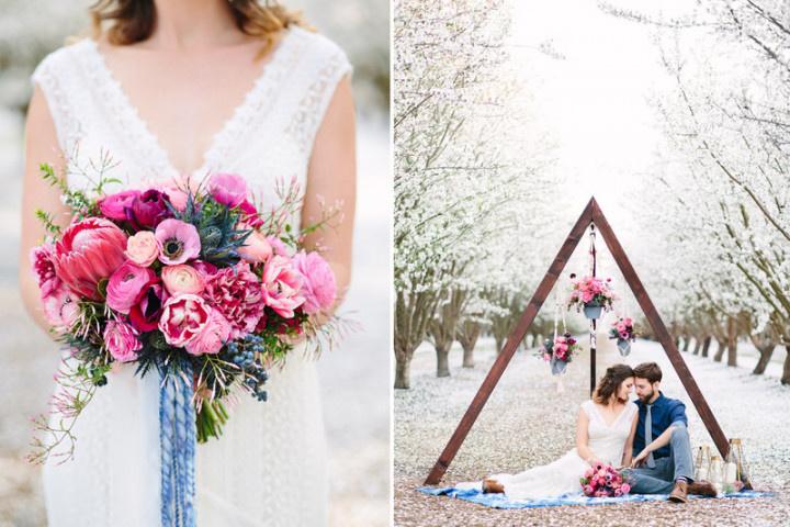 bride and groom pose at boho wedding with pink and blue decor