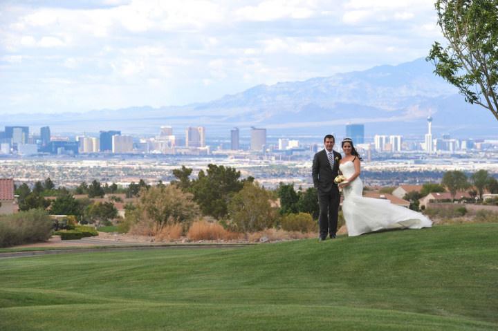 bride and groom pose at scenic Las Vegas golf resort overlooking downtown skyline