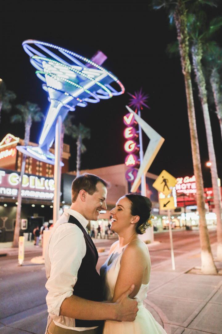 bride and groom pose on Las Vegas strip downtown Las Vegas wedding