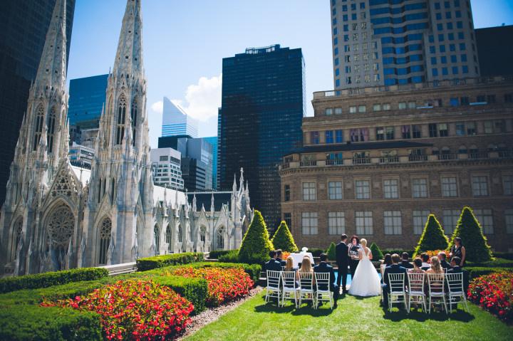 outdoor wedding venue on new york city rooftop garden with large church on left side