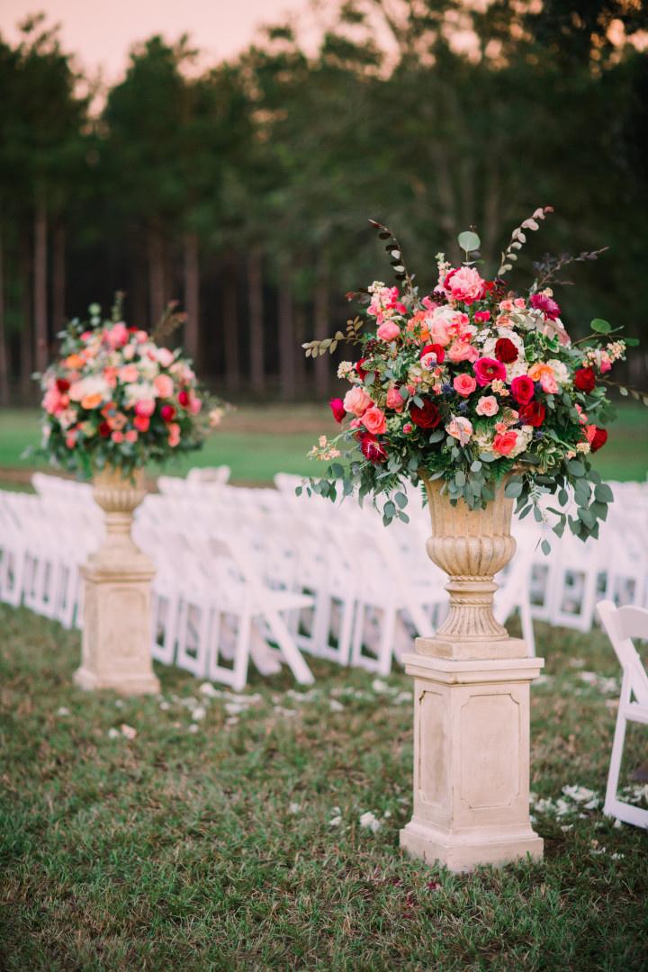two stone pillars mark each side of outdoor wedding ceremony aisle