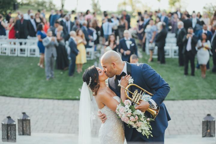bride and groom kiss after wedding ceremony