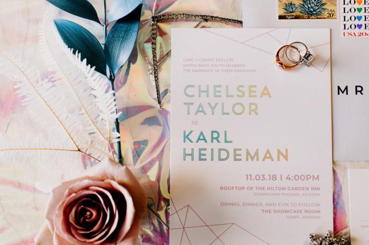 wedding invitation with holographic words in winter wedding colors like pastel pink and metallic gold