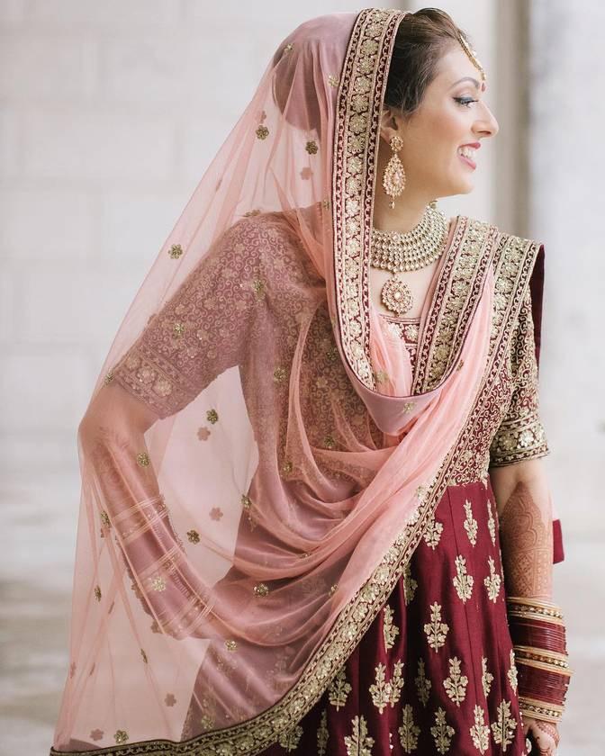 south asian bride with pink and red lehenga
