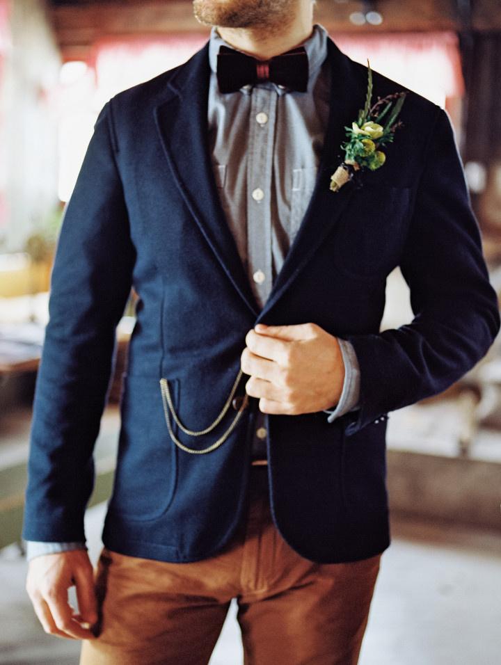 close up casual groom attire navy jacket chambray button down velvet bow tie brown slacks 