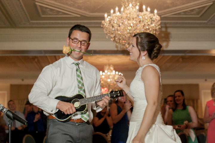 groom performing song at reception 