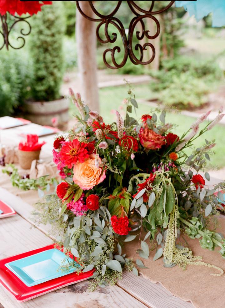 red and pink centerpiece with greenery