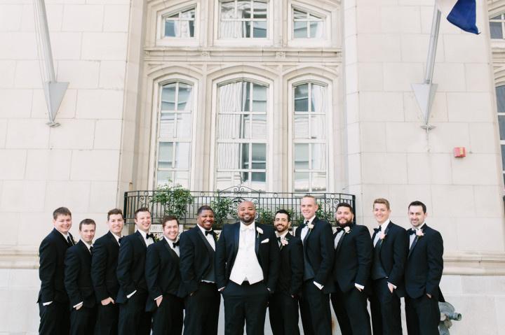 groom and groomsmen black tuxedos outdoor 