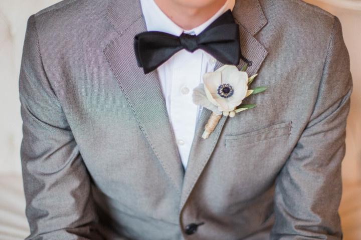 groom wearing gray suit with boutonniere 