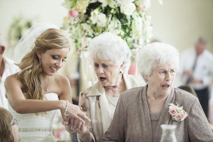 bride and grandmother looking at rings