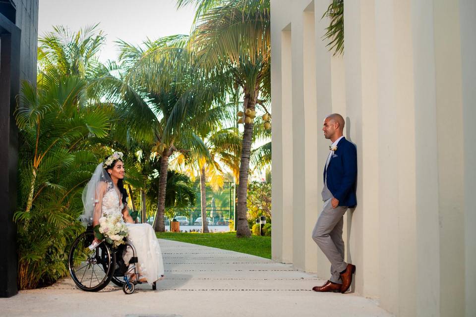 bride and groom looking at each other with tropical backdrop