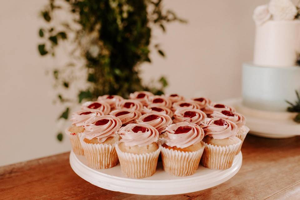 plate of cupcakes with pink frosting