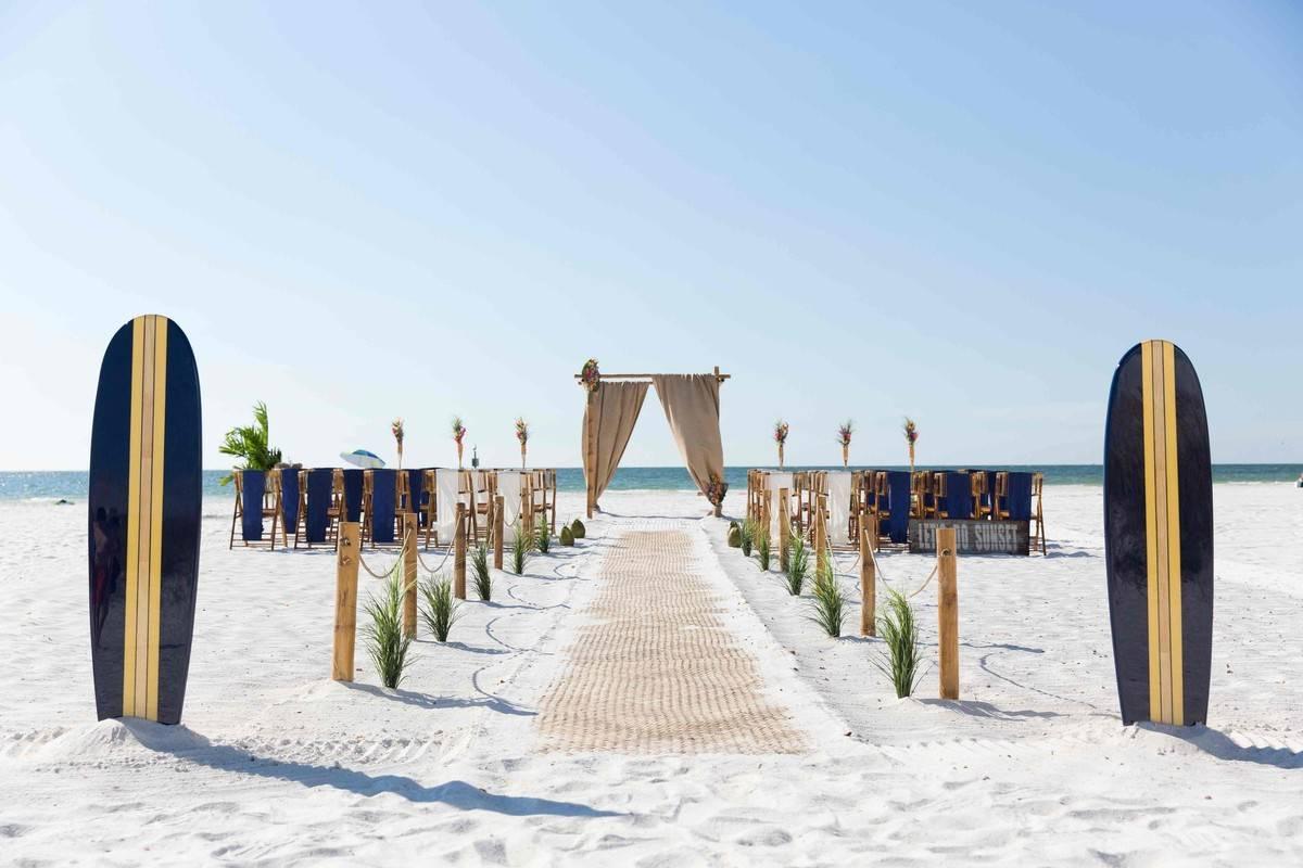 beach wedding ceremony decor surfboards at the entrance to the aisle