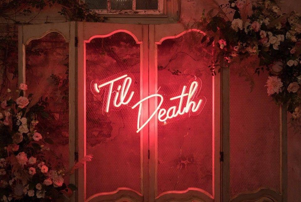 neon sign with 'til death written in pink letters