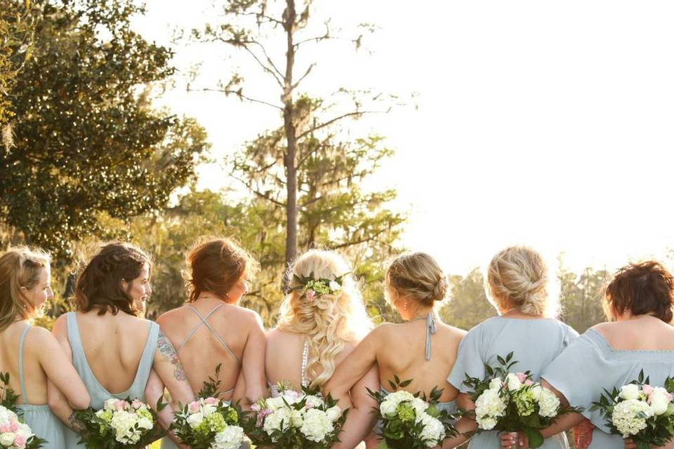 bridesmaids holding bouquets behind their backs