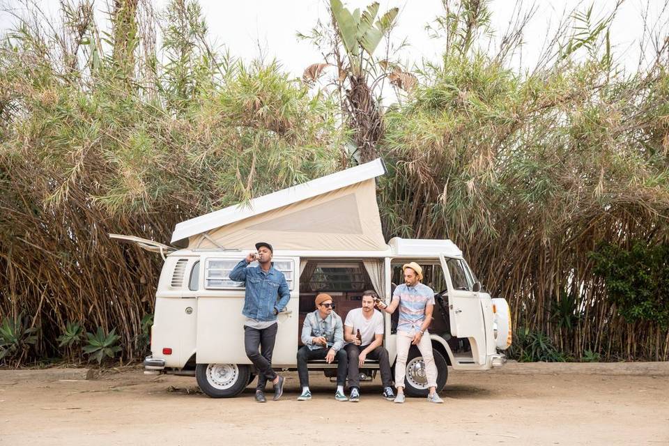 men drinking beers on a volkswagon van