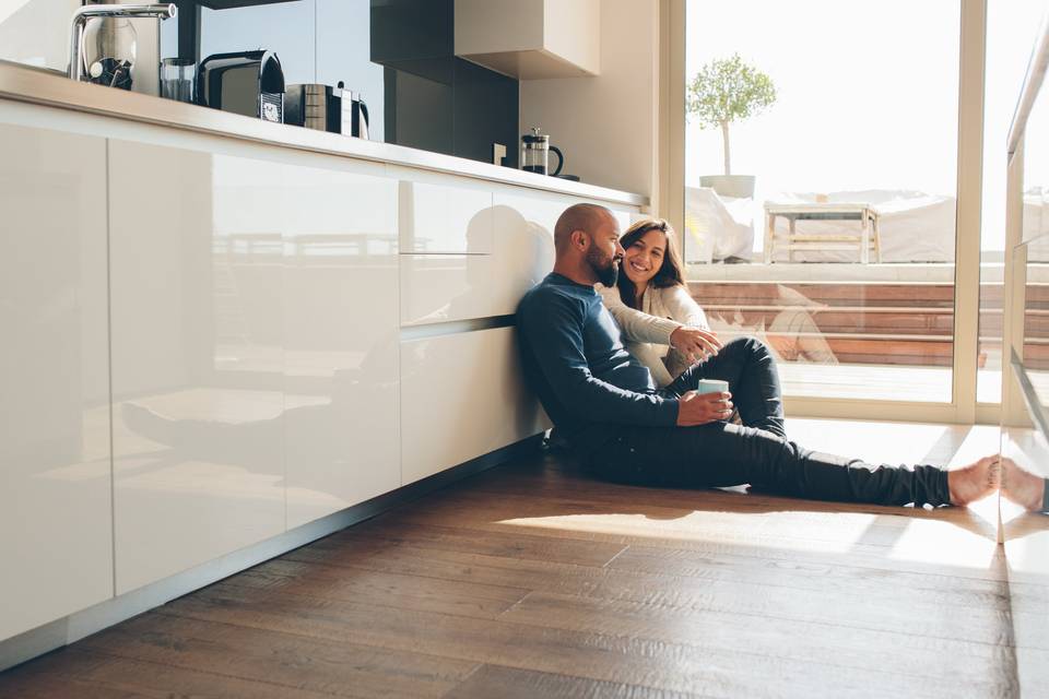 couple sitting on kitchen floor