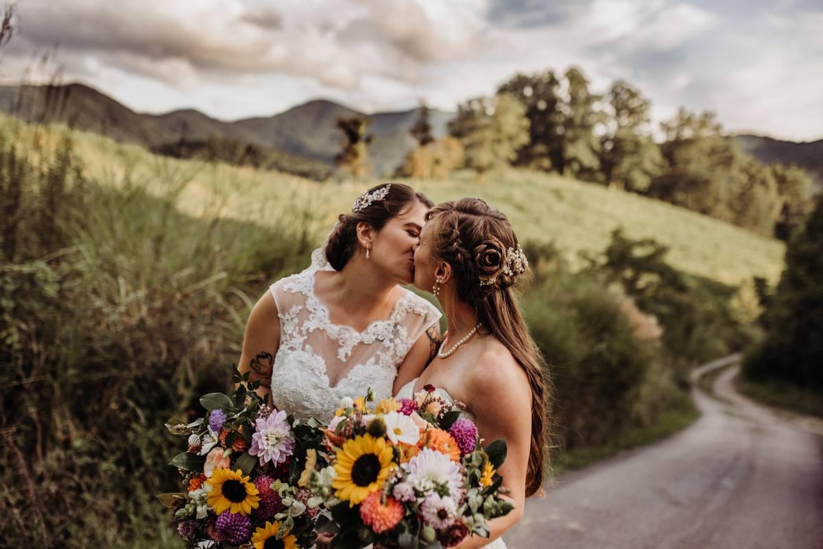 two brides kissing