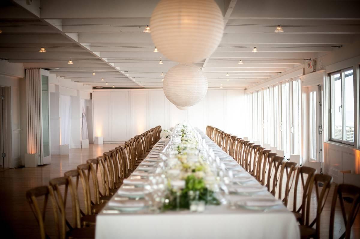 long farm table at indoor wedding reception