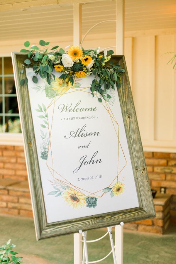 sunflower themed wedding welcome sign in wooden frame