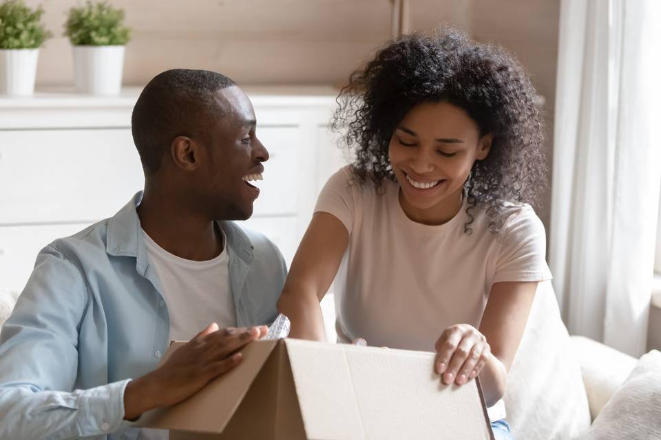 Couple smiling opening a package