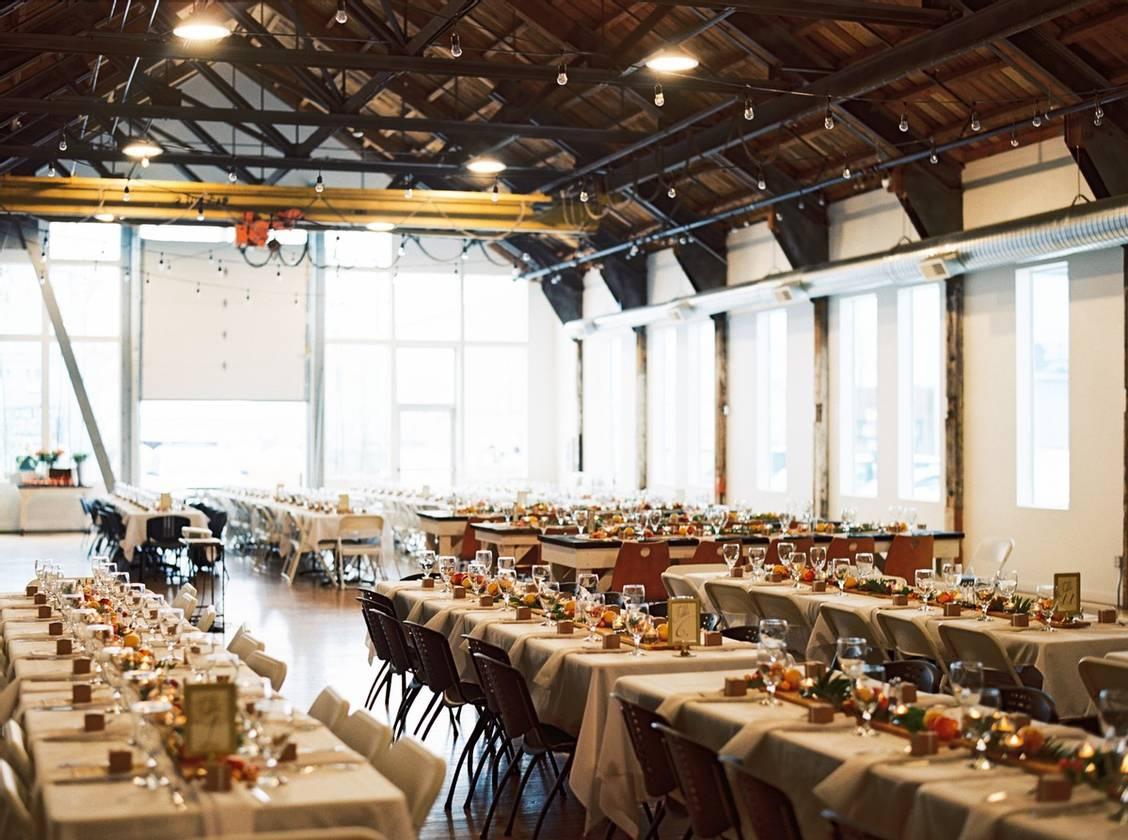 indoor wedding reception in industrial space with large windows