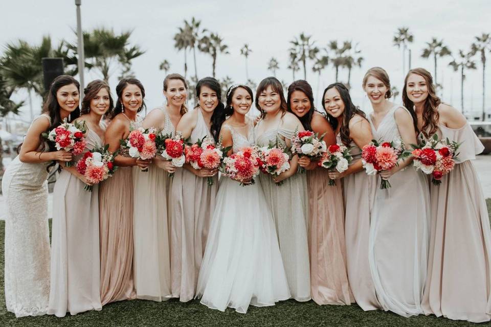 bride and bridesmaids wearing blush dresses and holding bright pink bouquets