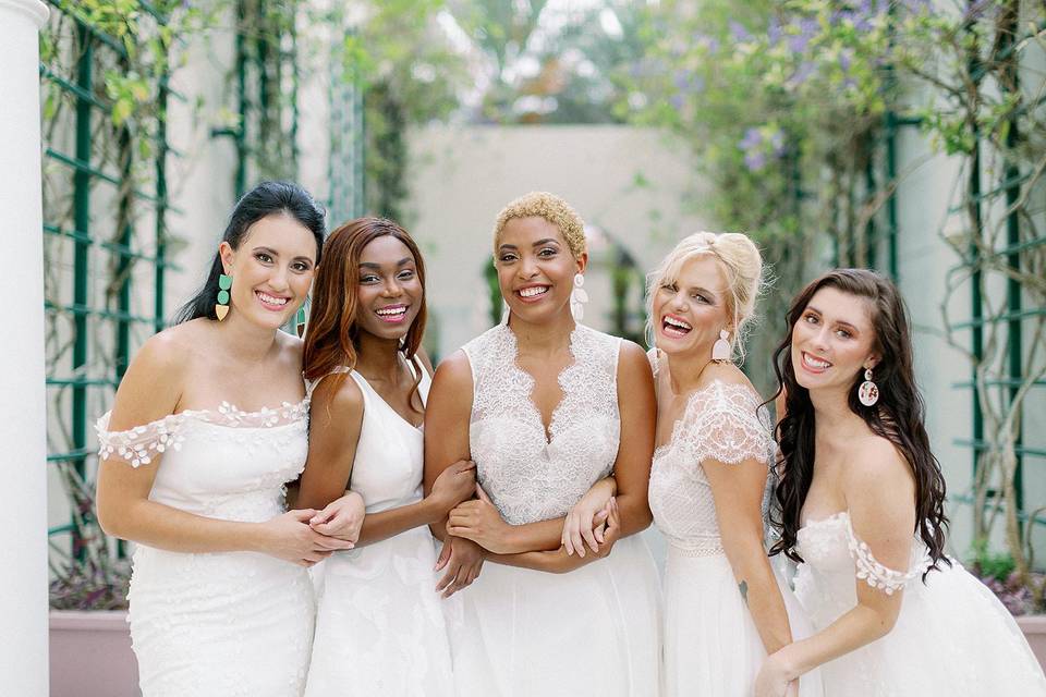 five brides smiling and laughing