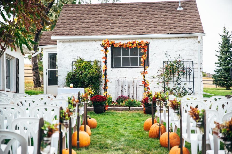 fall outdoor wedding aisle decor pumpkins at the end of each row