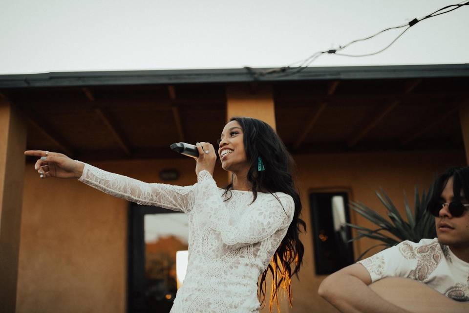 woman in white dress singing