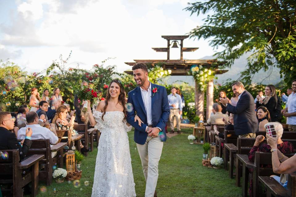 bride and groom smiling during wedding recessional