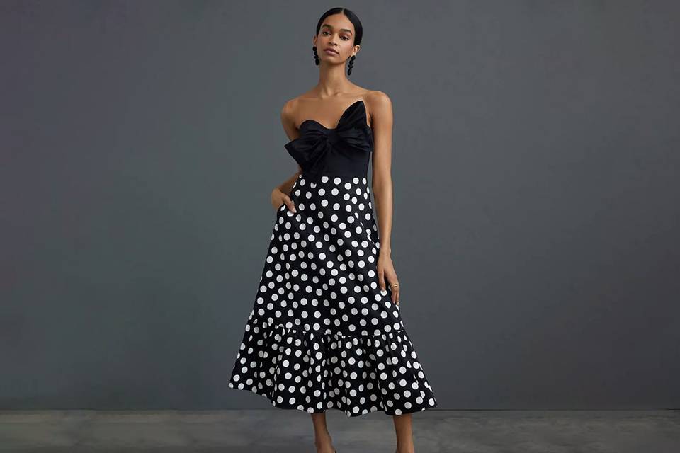 anthropologie black colorblocked strapless dress with bow chest and flowy white polka dot skirt with ruffle trim for engagement party dresses for guest