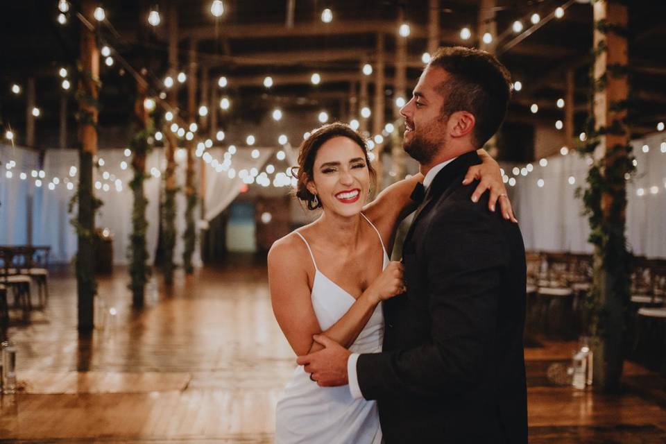 bride and groom at unique wedding venue with twinkle lights