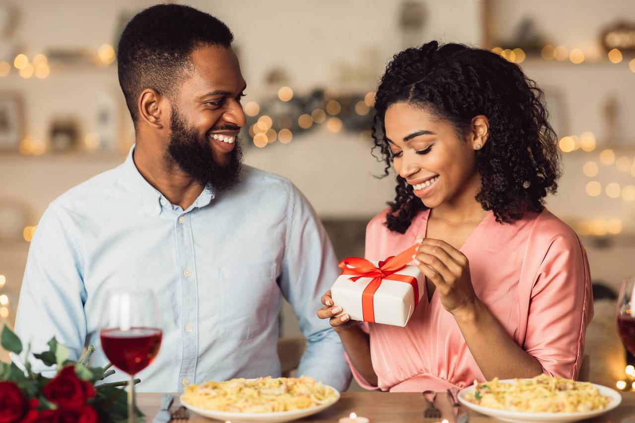 Happy african american friends eating pizza at home Stock Photo by  Prostock-studio