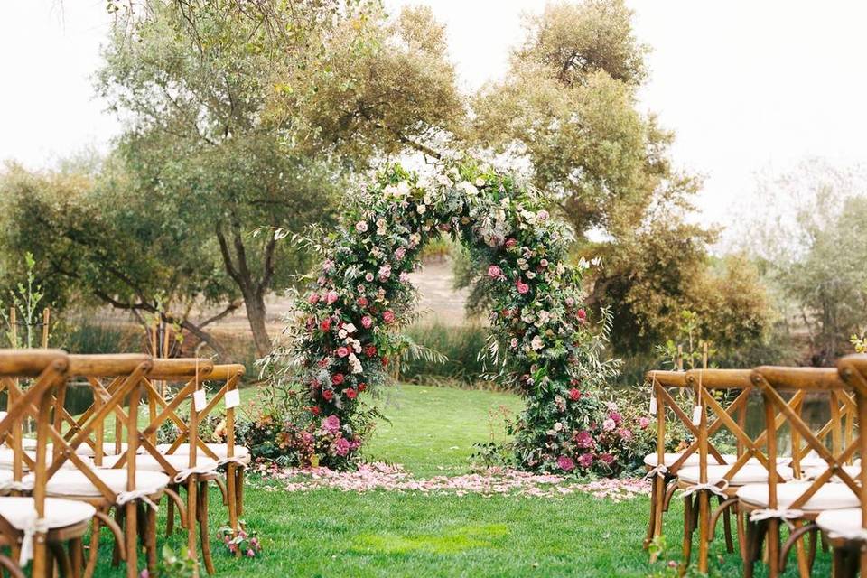 floral wedding arch with greenery and pink flowers