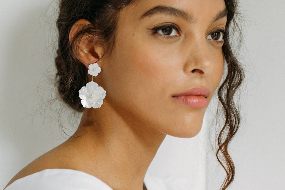 woman wearing white floral earrings