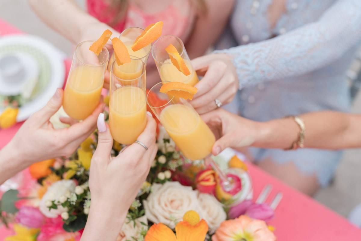 women toasting mimosas