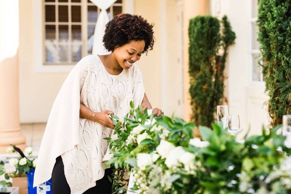 wedding florist setting up floral arrangements