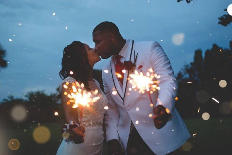 bride and groom holding sparklers