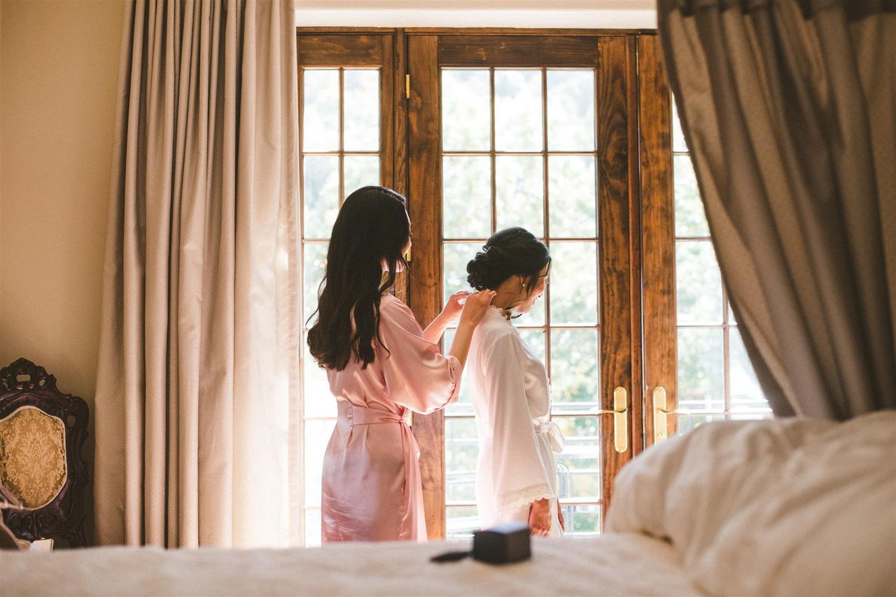 Bride wearing robe over wedding dress undergarments