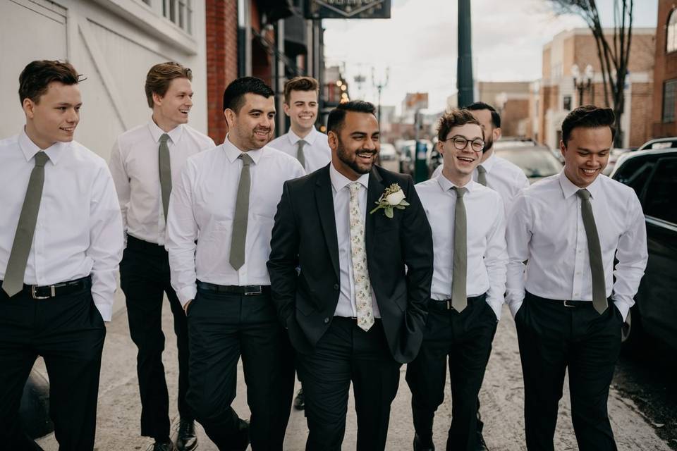 groom walking down the street with his groomsmen