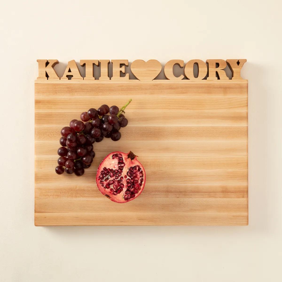 Wooden cutting board with block names and heart at top