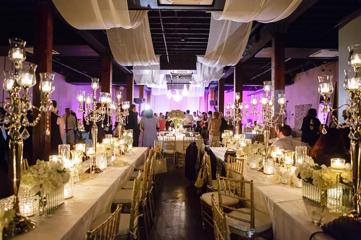 modern wedding reception with glamorous candelabra centerpieces and draped ceilings