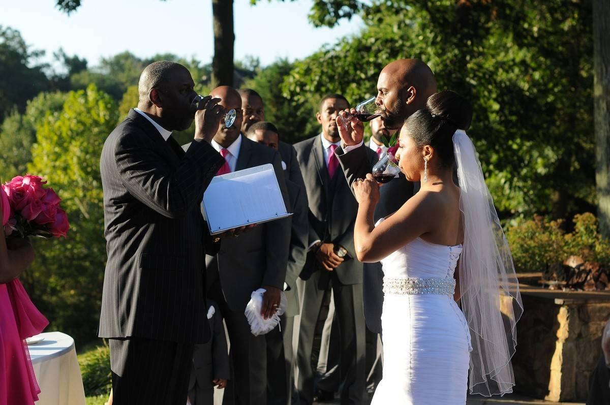 couple drinks wine during wedding ceremony